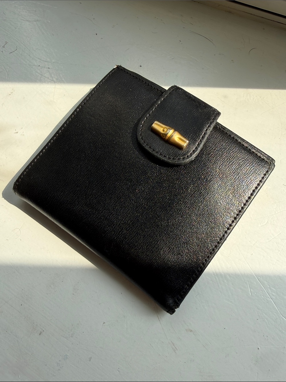 Longchamp Black Leather Bi-Fold Wallet with Gold Tone Closure